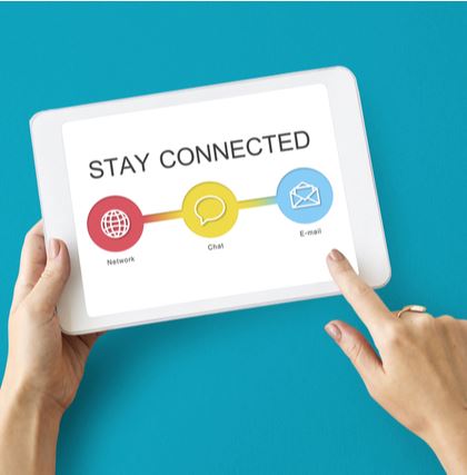 Hands holding a tablet with a screen that says stay connected
